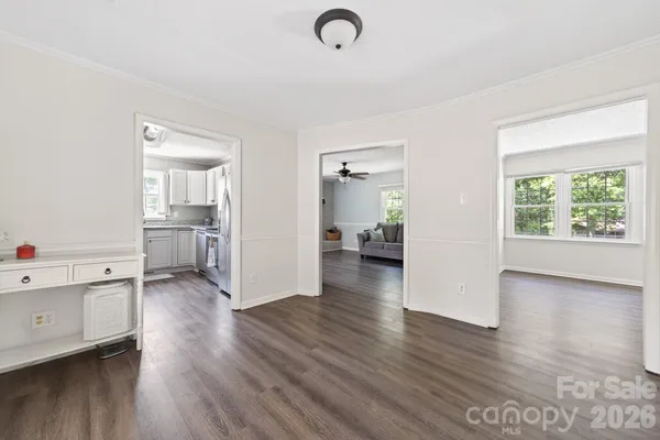 a view of a kitchen with wooden floor and windows
