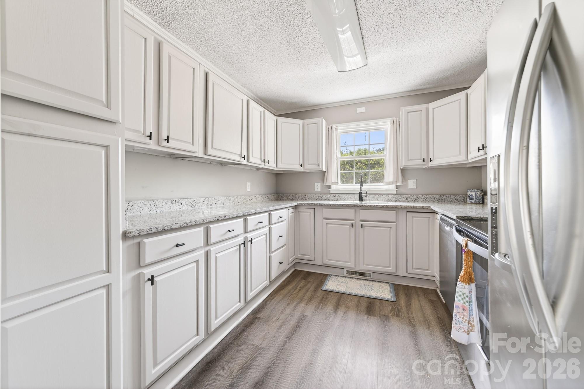 204 Harrelson Road Cherryville, NC 28021 - Photo 21 of 34 a kitchen with granite countertop white cabinets and white appliances