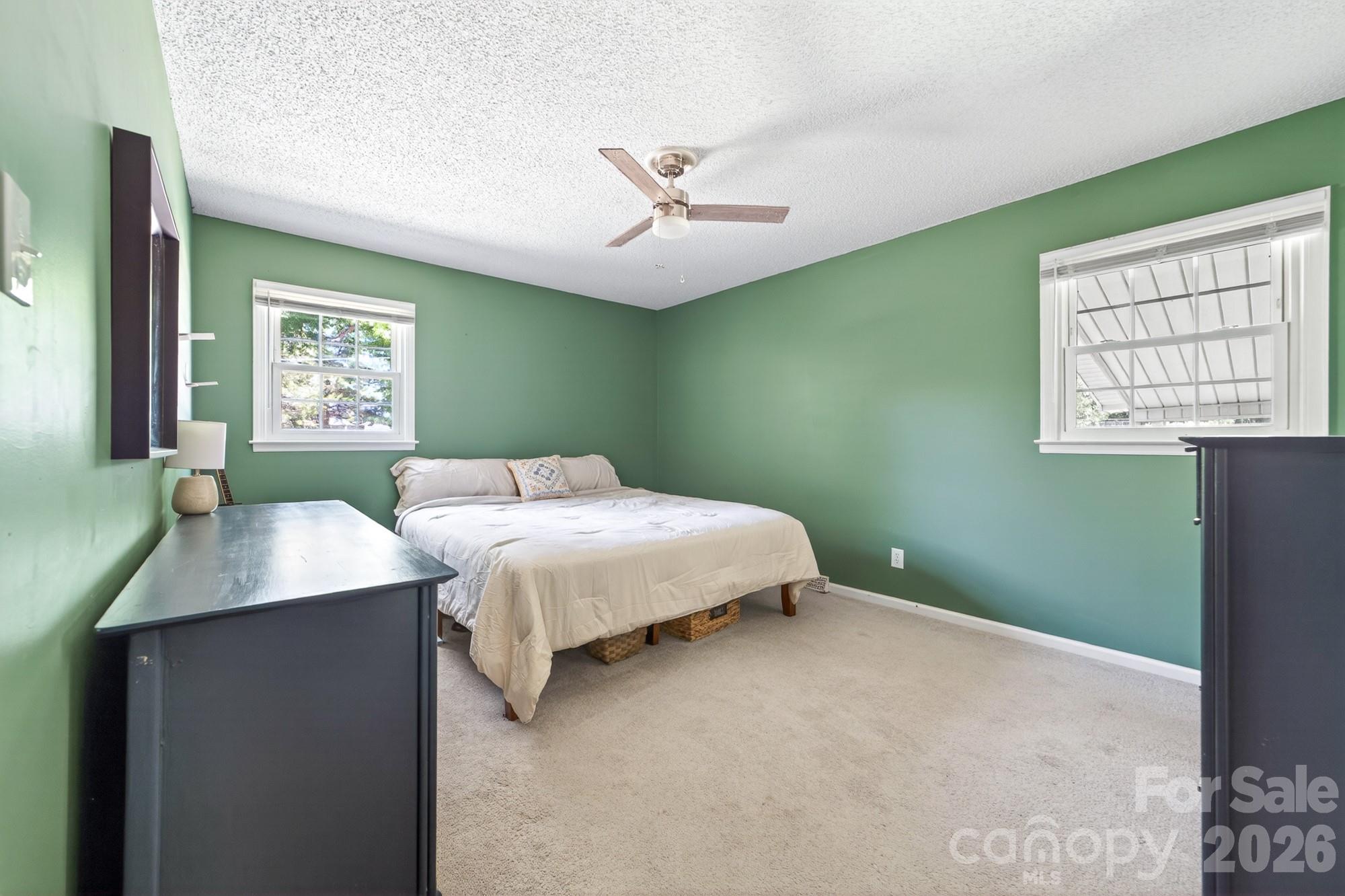 204 Harrelson Road Cherryville, NC 28021 - Photo 25 of 34 a bedroom with a bed and a chandelier