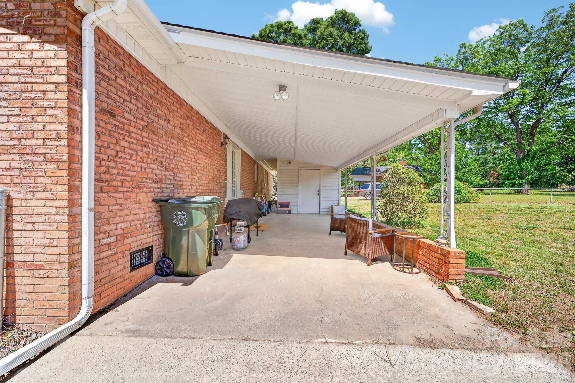204 Harrelson Road Cherryville, NC 28021 - Photo 8 of 34 a view of a patio with a table chairs potted plants and a palm tree