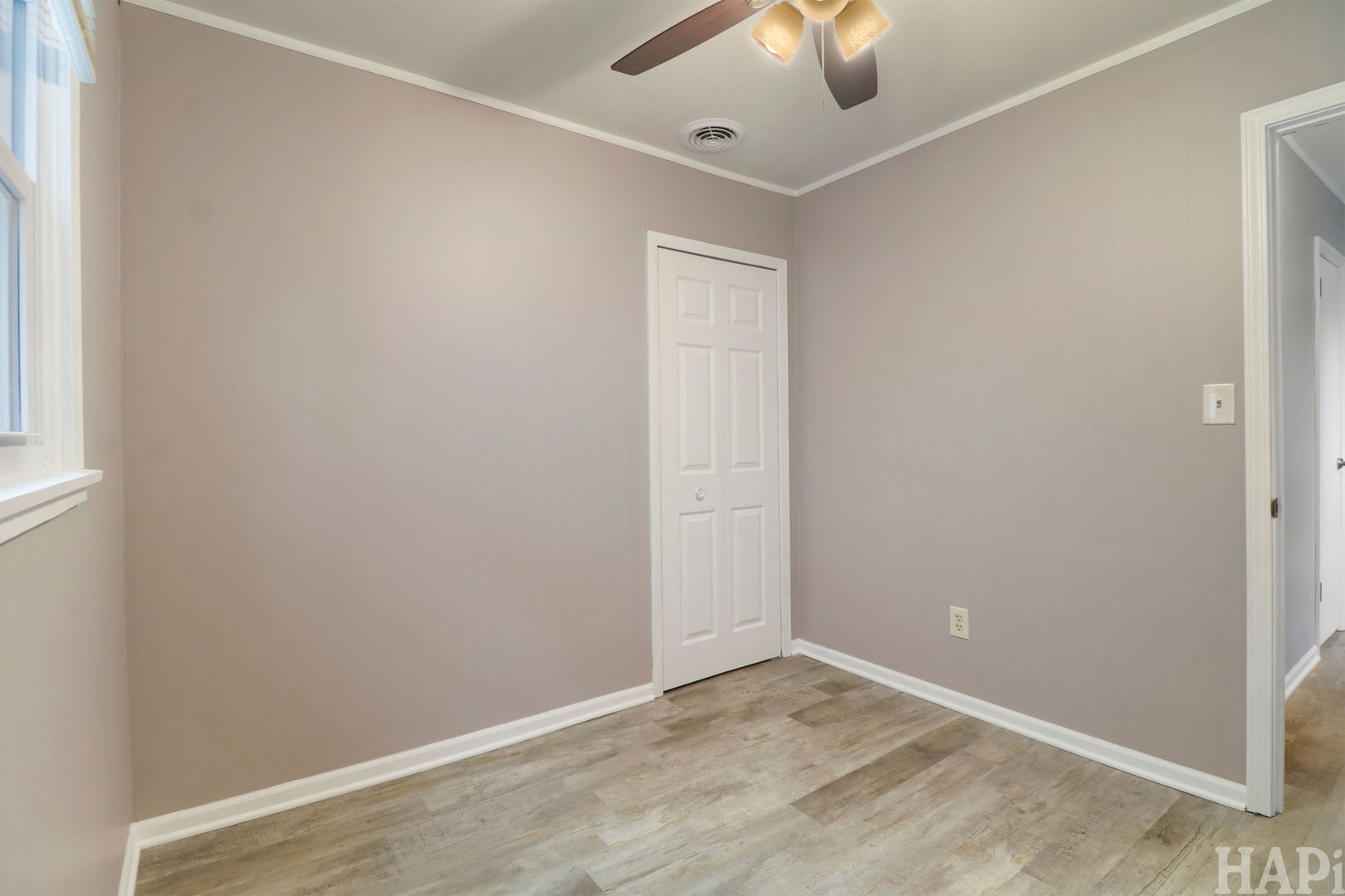 2217 20th Street Zion, IL 60099 - Photo 12 of 24 an empty room with a window and ceiling fan