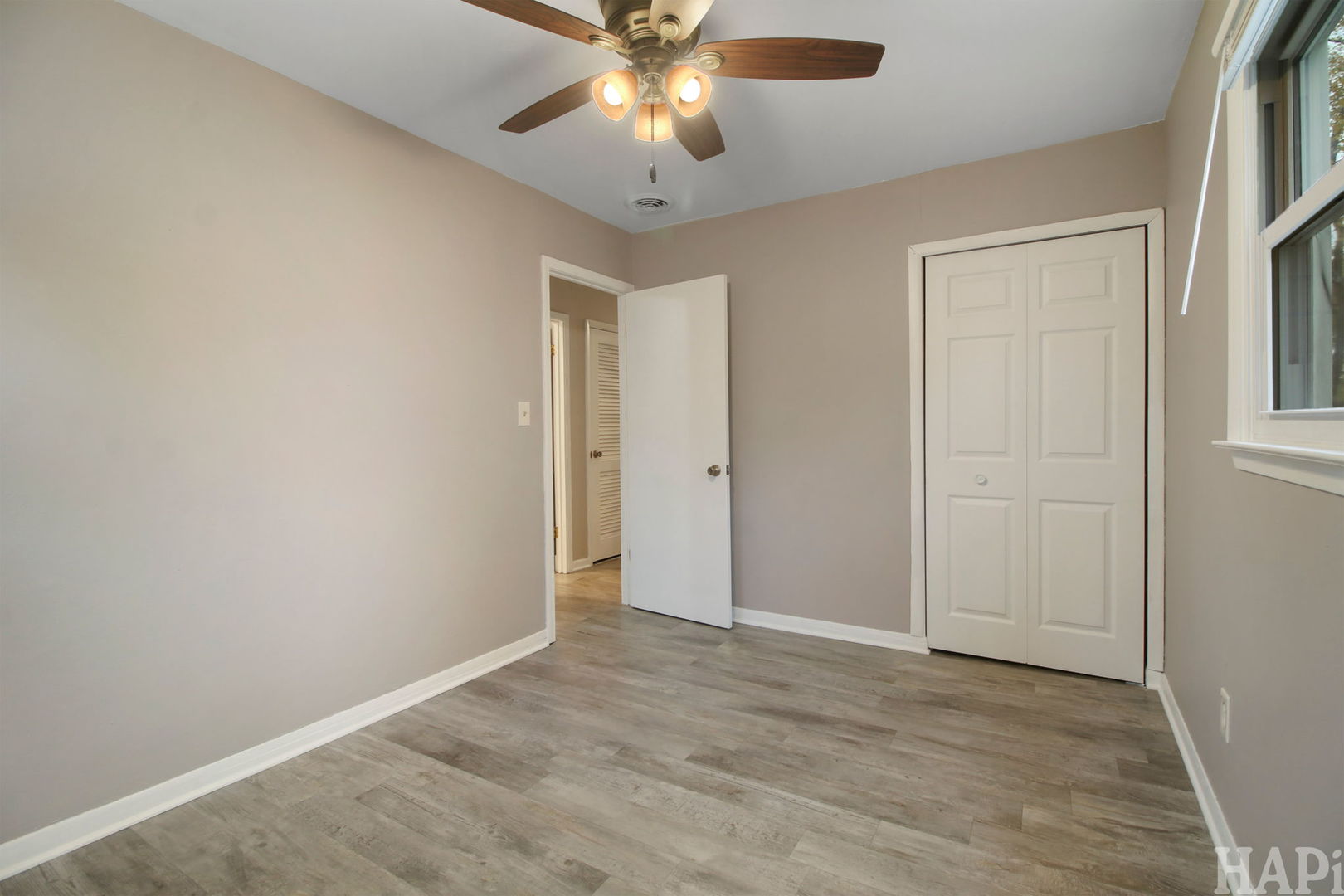 2217 20th Street Zion, IL 60099 - Photo 17 of 24 an empty room with closet and a chandelier fan