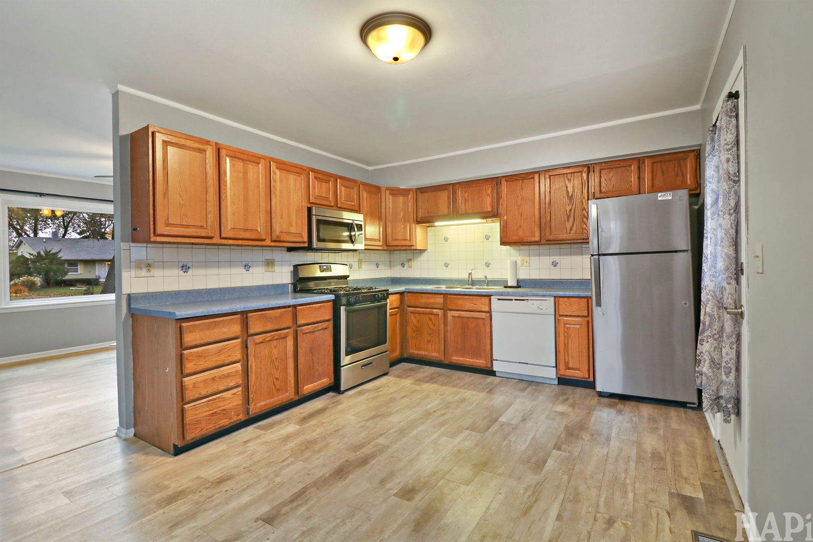 2217 20th Street Zion, IL 60099 - Photo 6 of 24 a kitchen with a sink a window and stainless steel appliances