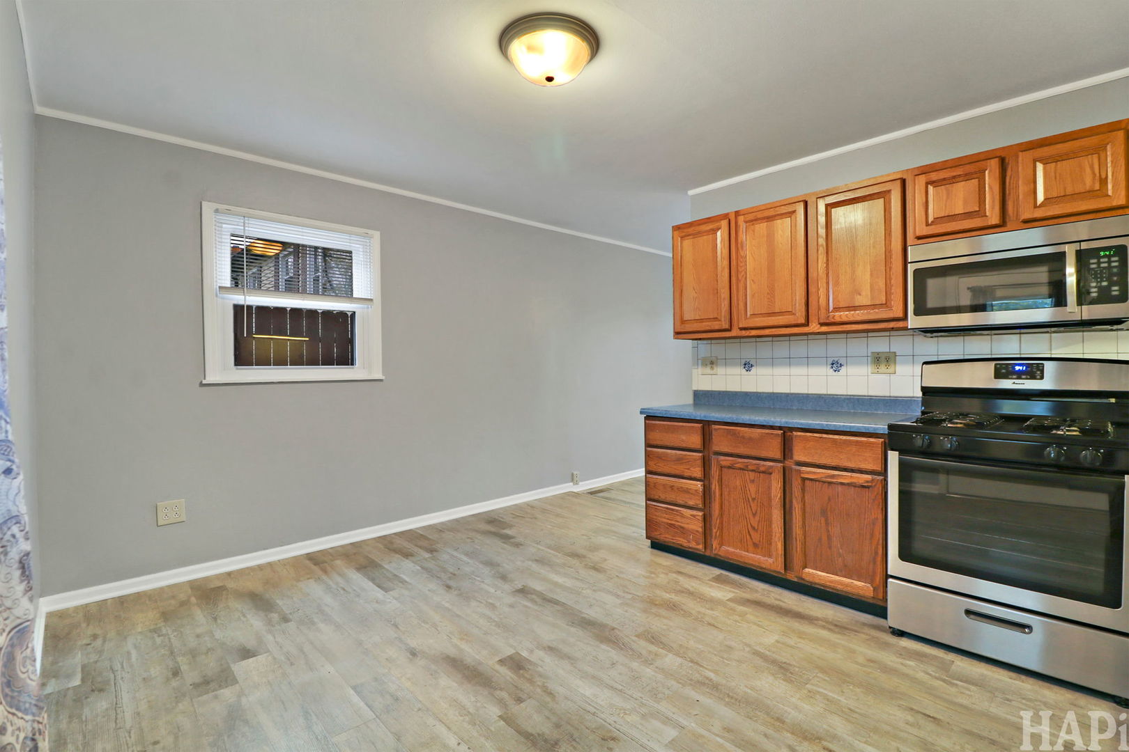 2217 20th Street Zion, IL 60099 - Photo 7 of 24 a kitchen with stainless steel appliances granite countertop a stove and cabinets