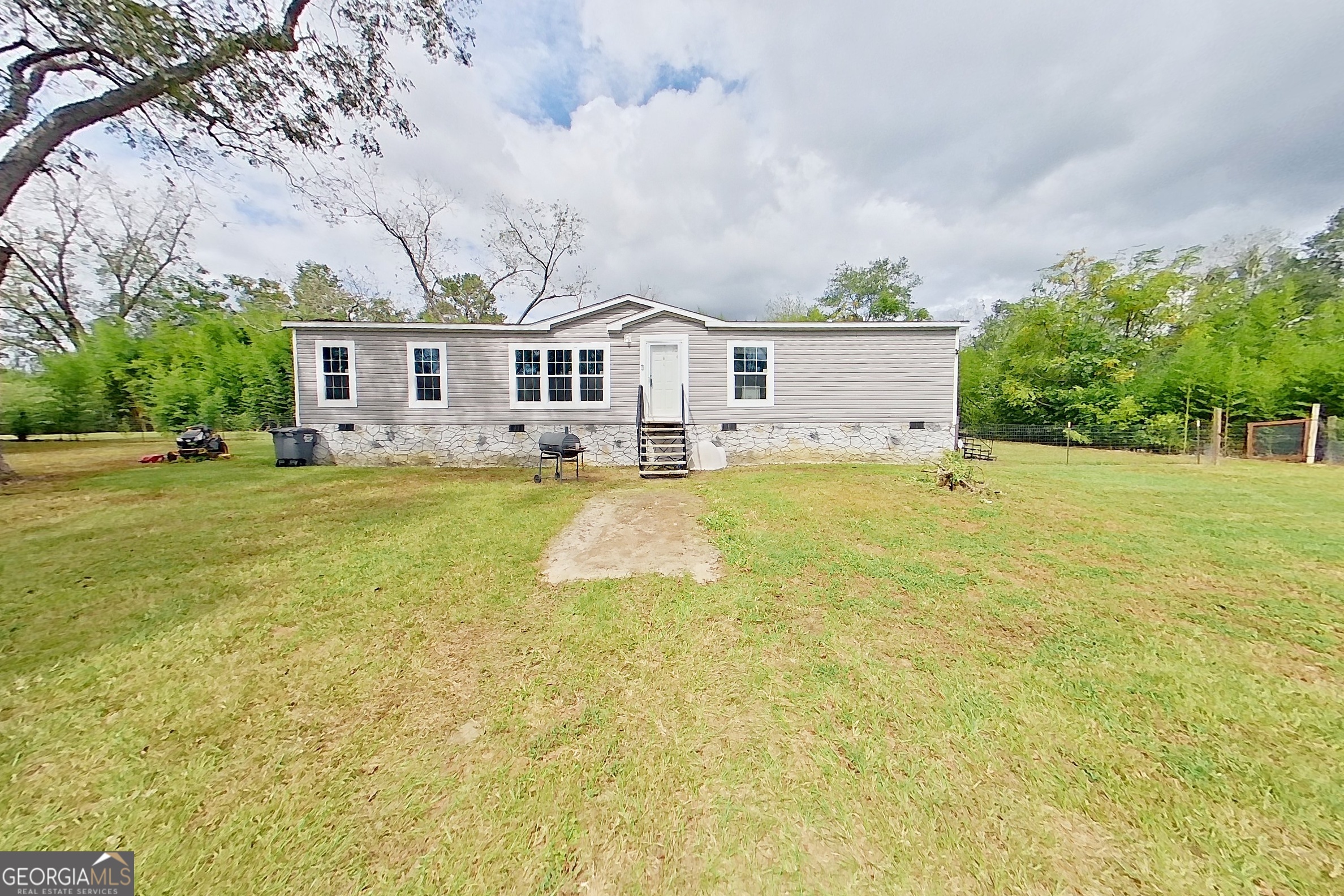 2545 Stage Coach Road Meigs, GA 31765 - Photo 1 of 1 a front view of a house with a garden and trees