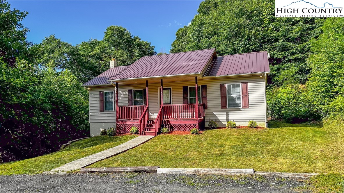 461 Jack Jones Road Lansing, NC 28643 - Photo 1 of 1 a view of a house with a yard patio and fire pit