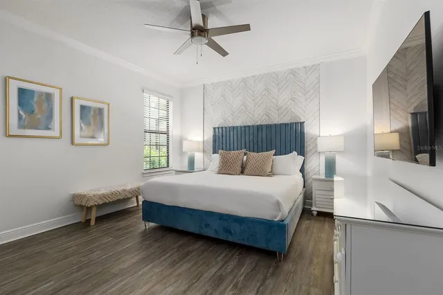 a room with pool table windows and wooden floor