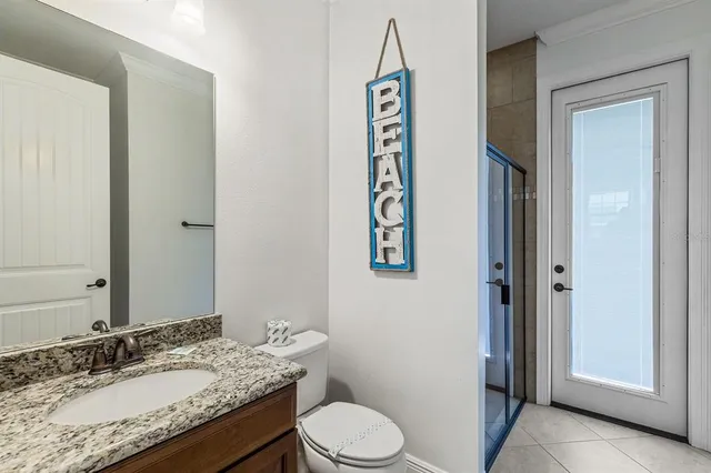 a kitchen with stainless steel appliances granite countertop a table chairs microwave and sink