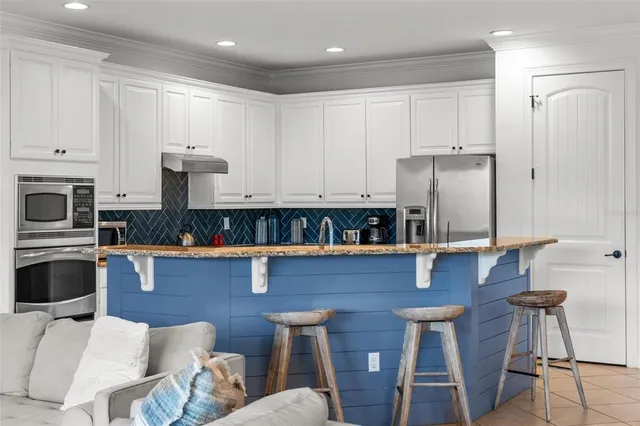 a view of kitchen with furniture and a refrigerator