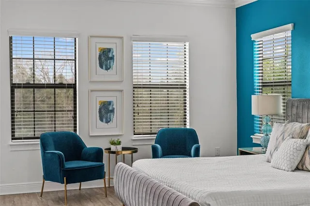 a spacious bedroom with a bed and a flat screen tv