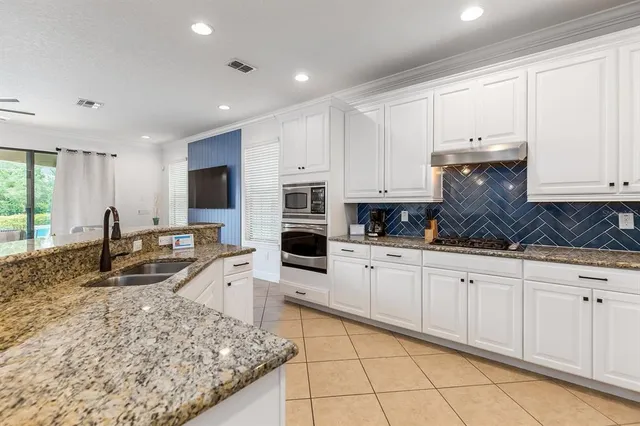 a kitchen with a refrigerator sink and cabinets