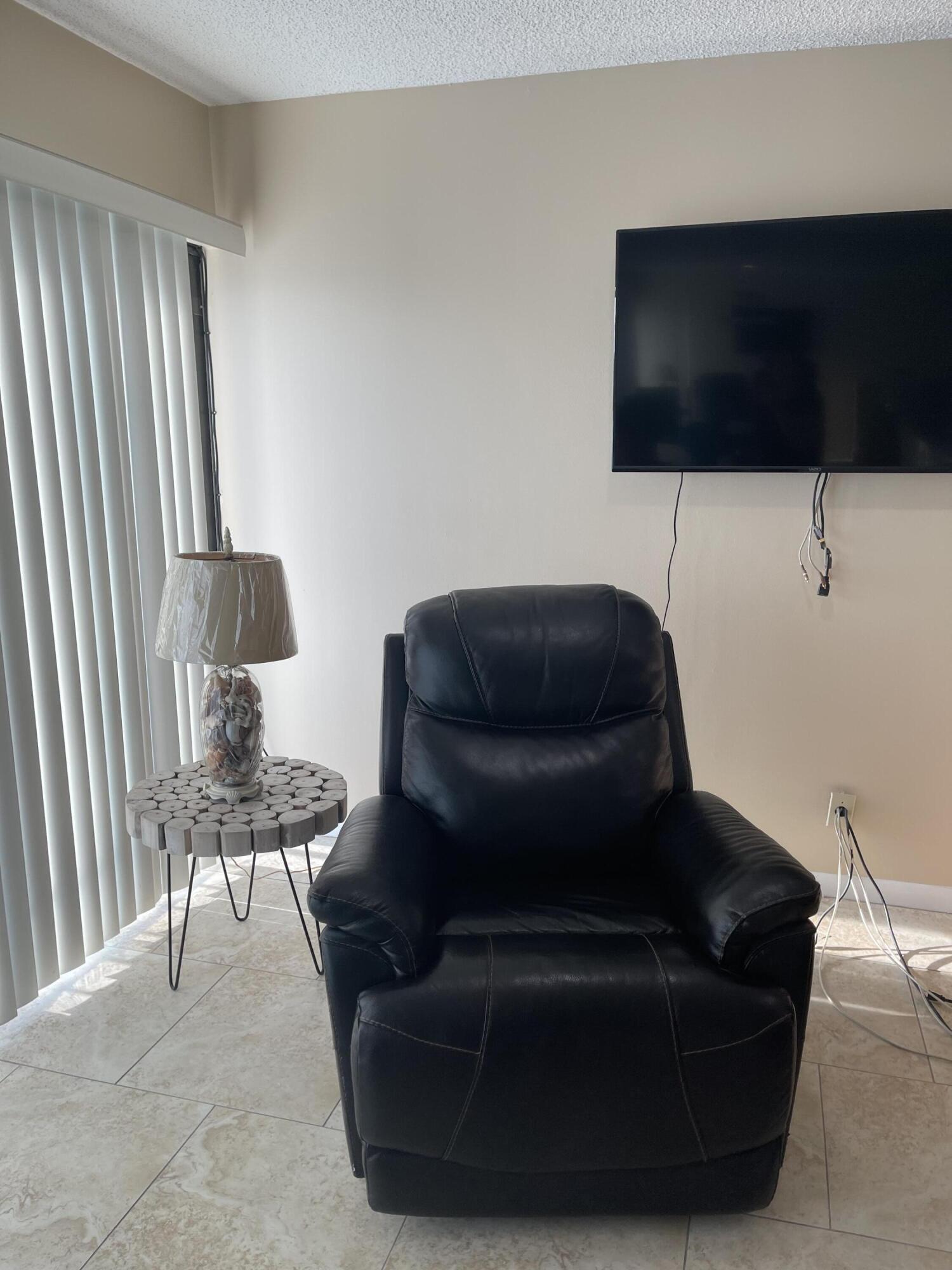 1605 Highway 1, Unit V6306 Jupiter, FL 33477 - Photo 13 of 34 a living room with furniture and a flat screen tv