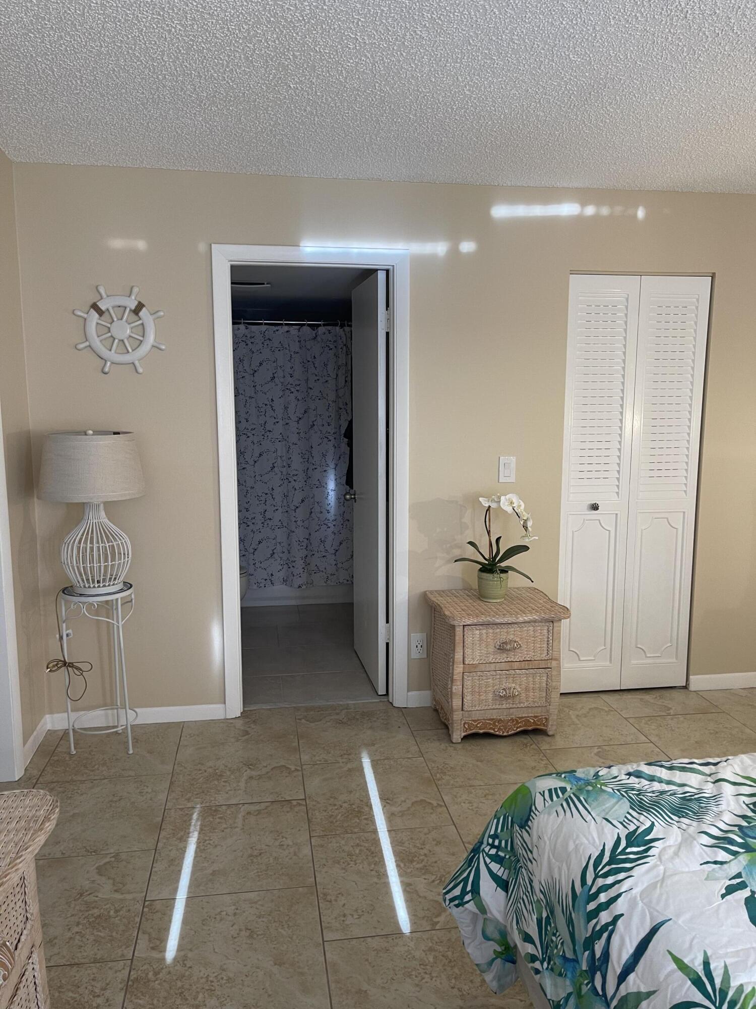 1605 Highway 1, Unit V6306 Jupiter, FL 33477 - Photo 20 of 34 a bedroom with a bed and a table
