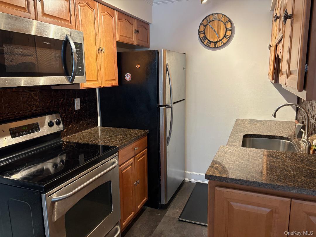 204 Millard Avenue, Unit 204 West Babylon, NY 11704 - Photo 6 of 22 a kitchen with a stove and a microwave