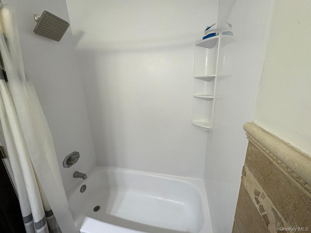 204 Millard Avenue, Unit 204 West Babylon, NY 11704 - Photo 8 of 22 a bathroom with a bathtub