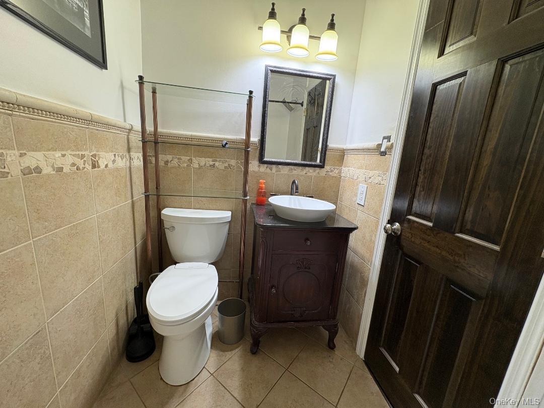 204 Millard Avenue, Unit 204 West Babylon, NY 11704 - Photo 9 of 22 a bathroom with a toilet and a mirror