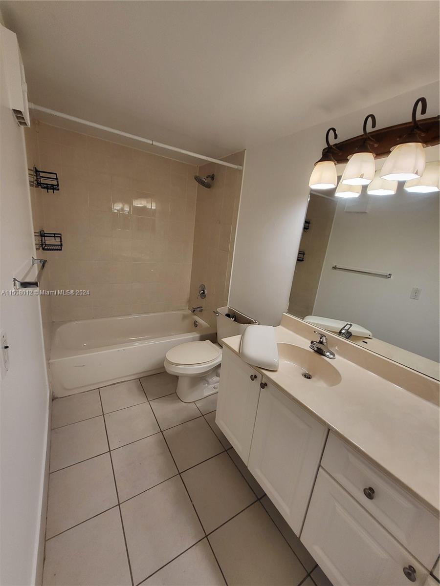 711 North Pine Island Road, Unit 111 Plantation, FL 33324 - Photo 8 of 14 a bathroom with a sink a toilet and shower