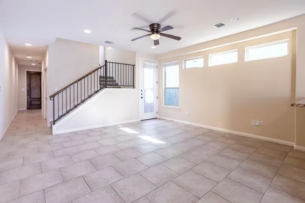 a view of entryway and hall with a ceiling fan