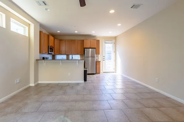 a view of a kitchen with a sink and a refrigerator