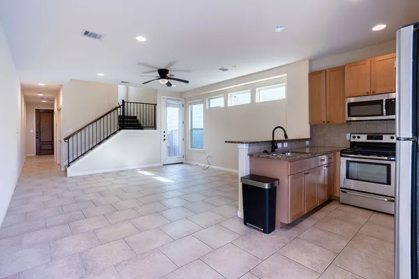 a kitchen with granite countertop a sink and stainless steel appliances