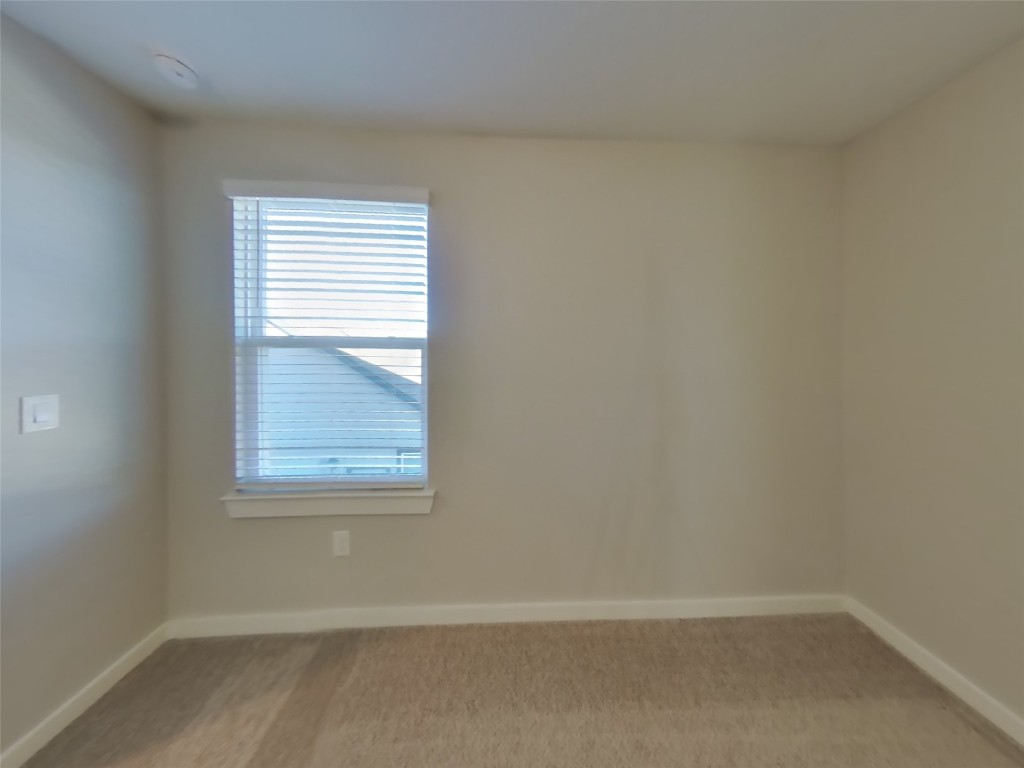 620 Raglands Road Leander, TX 78641 - Photo 12 of 30 Unfurnished room with light colored carpet and baseboards