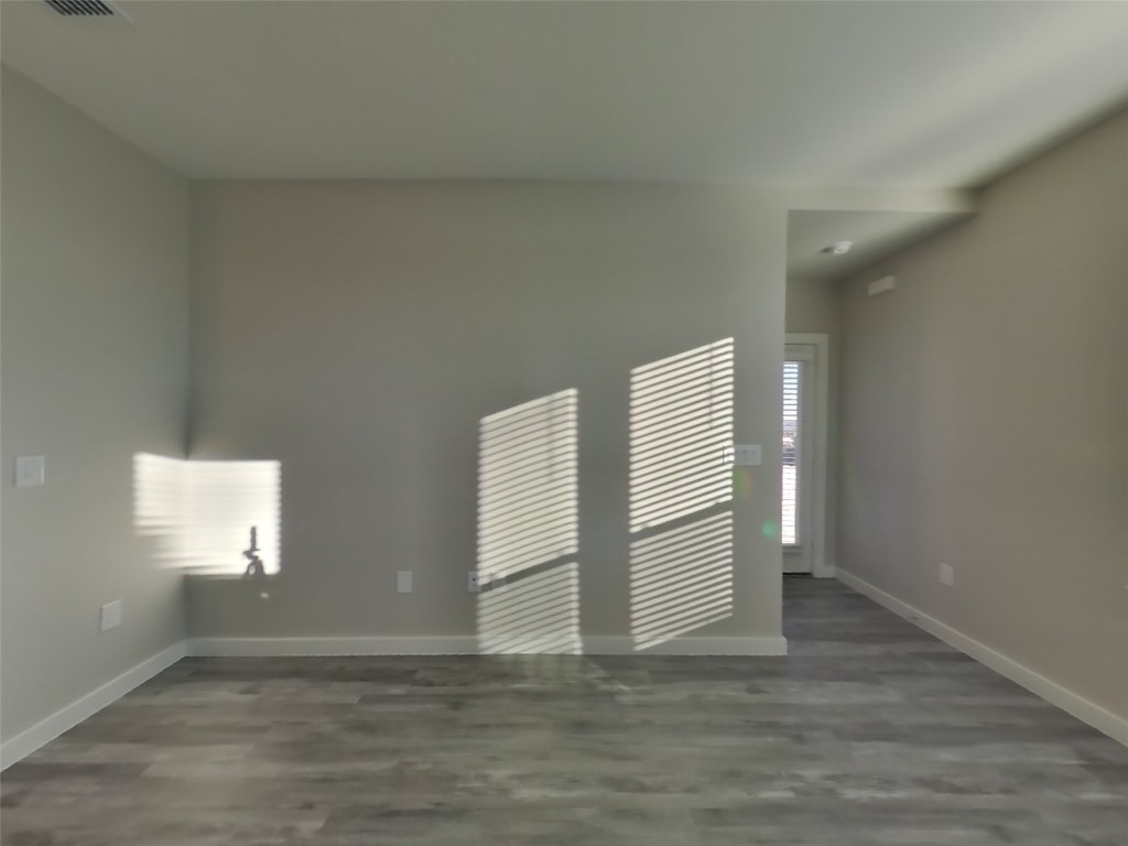 620 Raglands Road Leander, TX 78641 - Photo 2 of 30 Empty room with baseboards and dark wood-style floors