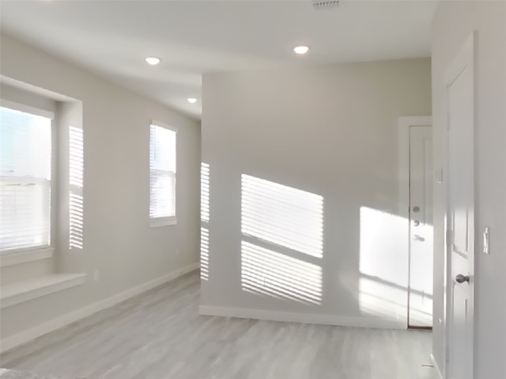 620 Raglands Road Leander, TX 78641 - Photo 3 of 30 Unfurnished room with light wood-style floors and recessed lighting