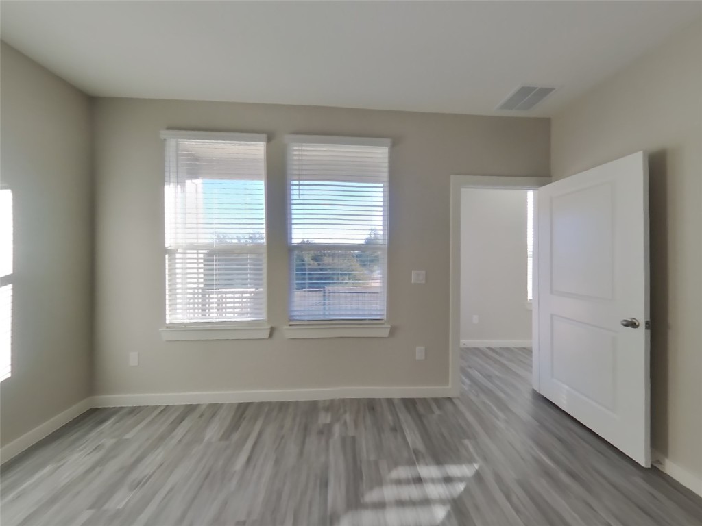 620 Raglands Road Leander, TX 78641 - Photo 6 of 30 Empty room featuring light wood finished floors and baseboards
