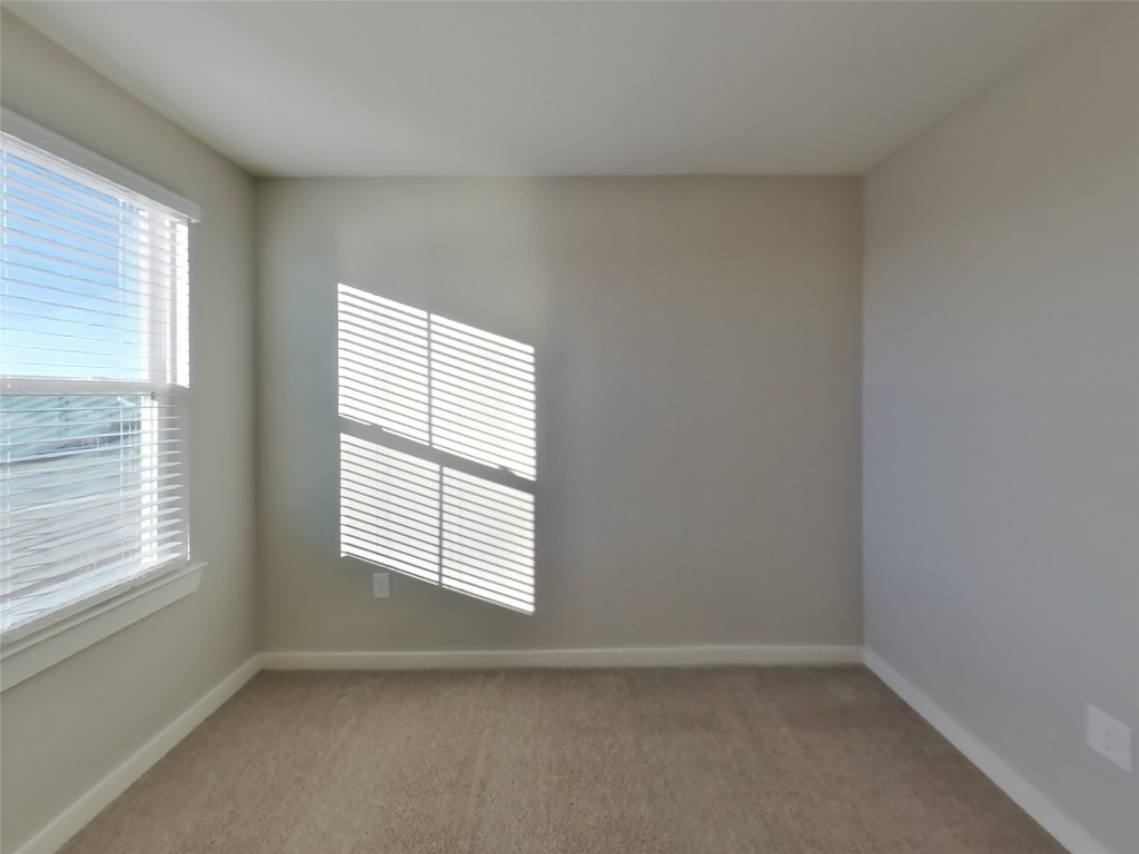 620 Raglands Road Leander, TX 78641 - Photo 9 of 30 Unfurnished room with light carpet and baseboards