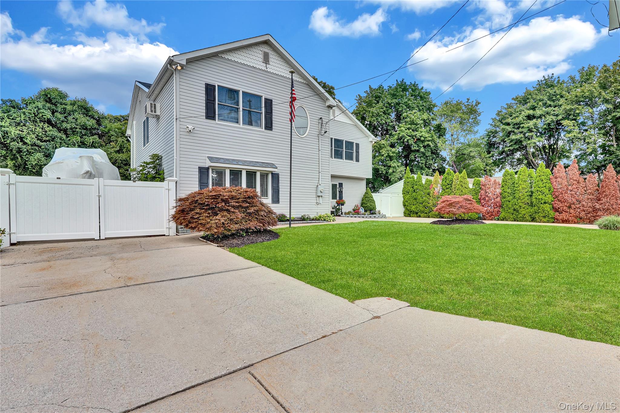 420 Dare Road Selden, NY 11784 - Photo 3 of 42 Left Side Driveway View w/ Double Gate to left side of Home