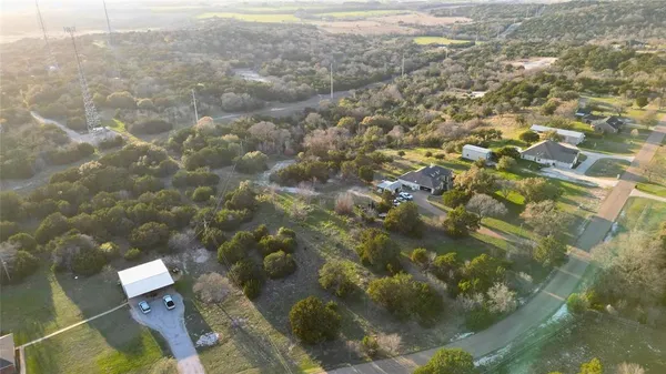 an aerial view of residential houses with yard