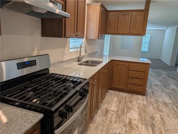 a kitchen with wooden cabinets and a stove top oven