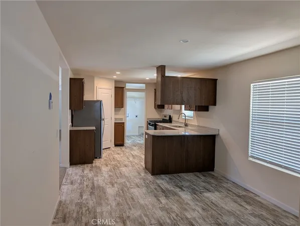 a kitchen with stainless steel appliances granite countertop a refrigerator and a stove top oven