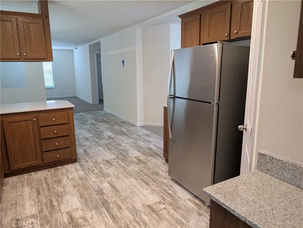 a kitchen with a refrigerator and cabinets