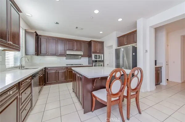 a large kitchen with a table and chairs in it