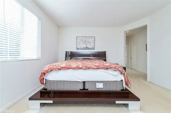 a spacious bathroom with a granite countertop double vanity sink a large mirror a bathtub and window