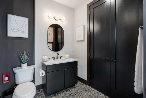 a bathroom with a toilet sink and mirror