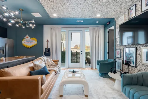 a living room with furniture and a chandelier