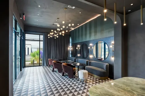 a lobby with furniture and chandelier