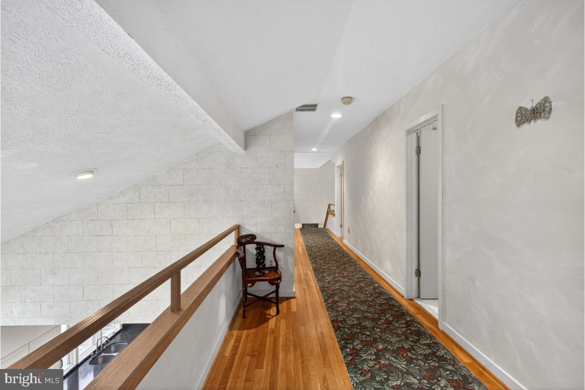 10320 Glen Road Potomac, MD 20854 - Photo 40 of 75 a view of a hallway with wooden floor