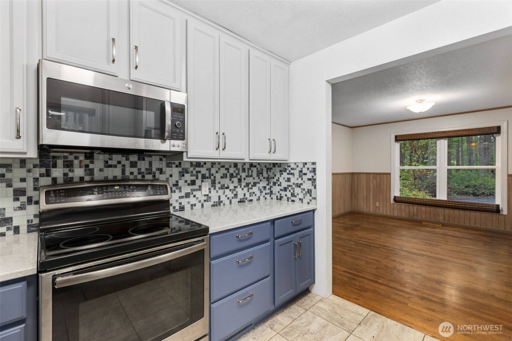 100 East Twanoh Heights Road South Belfair, WA 98528 - Photo 13 of 40 a kitchen with granite countertop a stove and a microwave