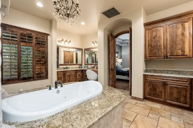 a bedroom with a bed and a tv on the dresser