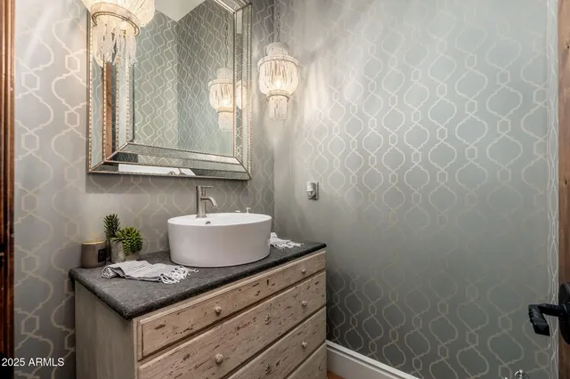 a bathroom with a sink a mirror and a shower