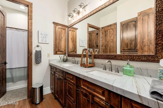 a bathroom with a granite countertop sink a toilet and a mirror