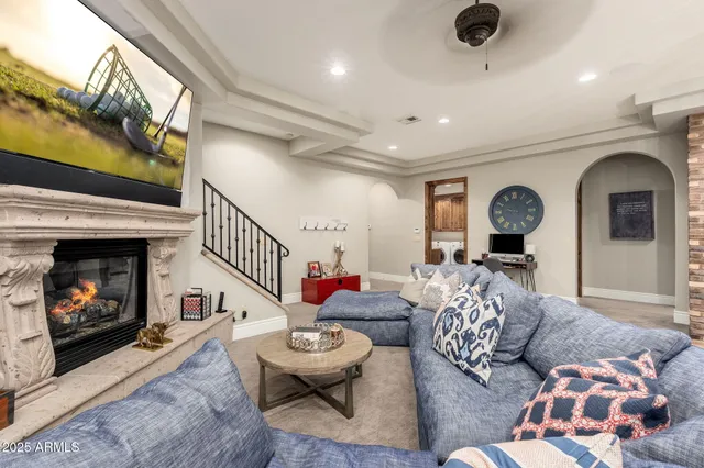 a view of a patio with couches table and chairs with wooden fence and plants