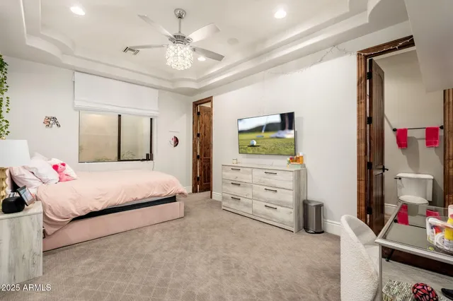 a living room with furniture and large windows