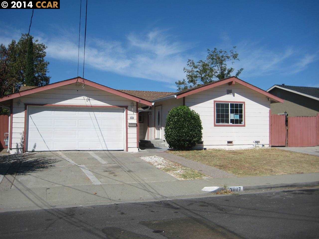 a view of a house with a yard and garage