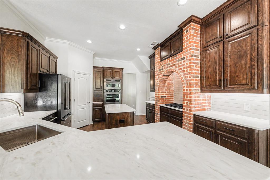 1200 Mount Gilead Road Keller, TX 76262 - Photo 14 of 38 a kitchen with stainless steel appliances kitchen island granite countertop a refrigerator stove and sink
