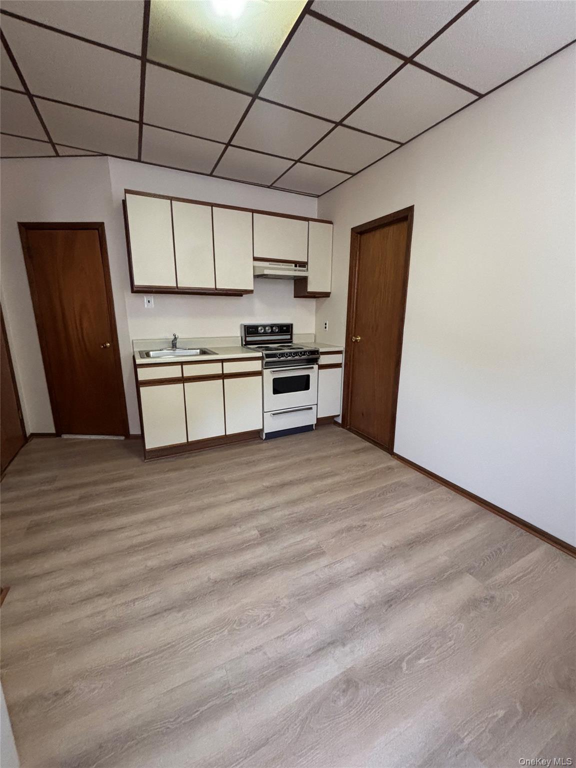 55-12 Van Cleef Street Queens, NY 11368 - Photo 2 of 8 a kitchen with stainless steel appliances a refrigerator and a stove