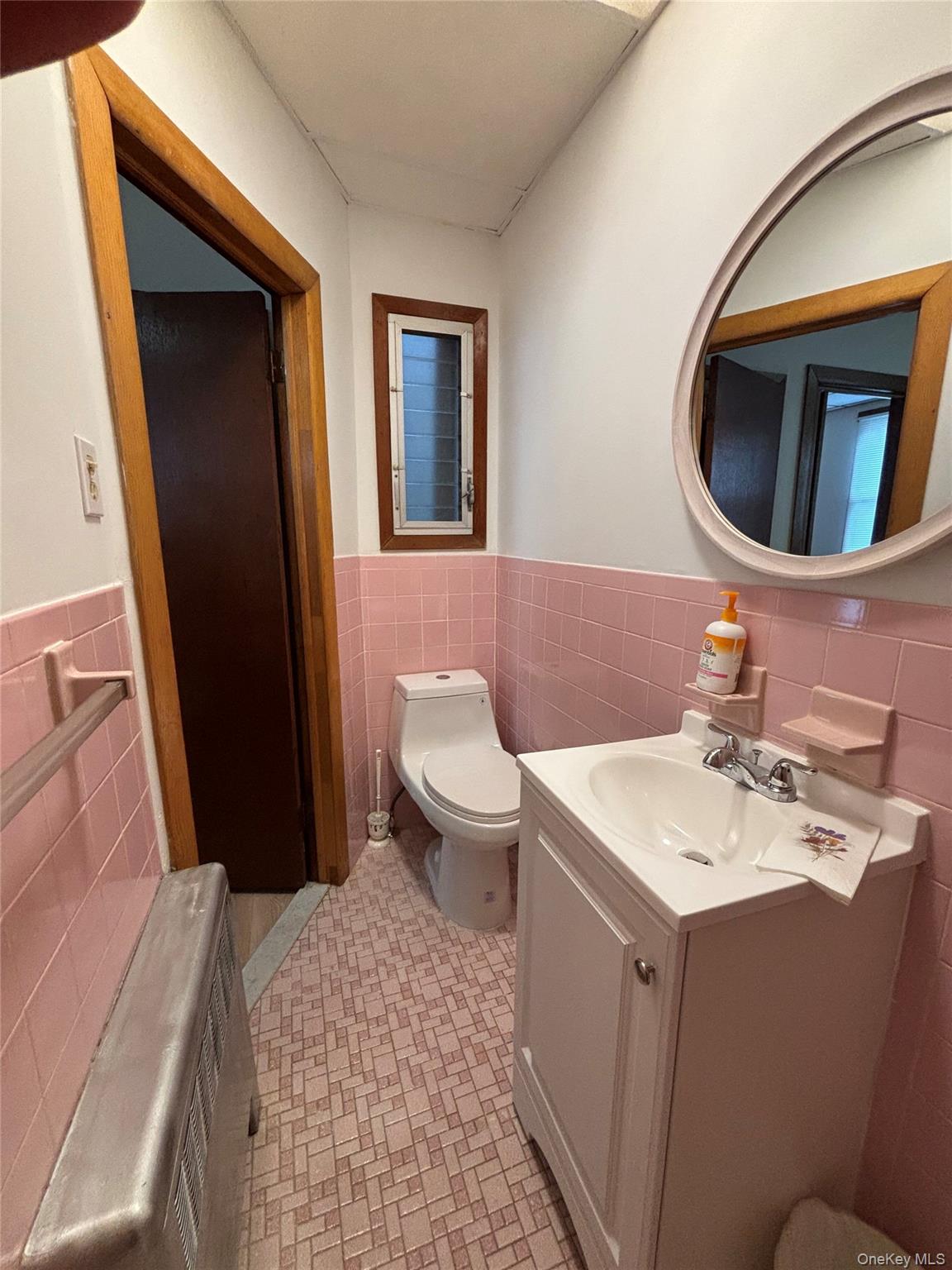 55-12 Van Cleef Street Queens, NY 11368 - Photo 8 of 8 a bathroom with a sink a toilet and mirror